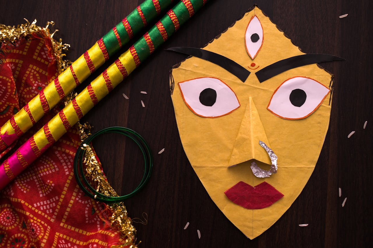 Colorful Navratri items, including Indian mask and dandiya sticks, on display.